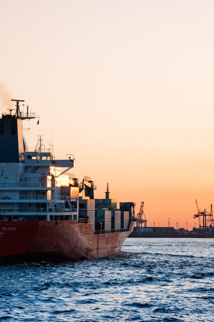 pexels-photo-799091-799091 Stunning sunset view of cargo ships and cranes at the Port of Hamburg, epitomizing global trade and logistics.